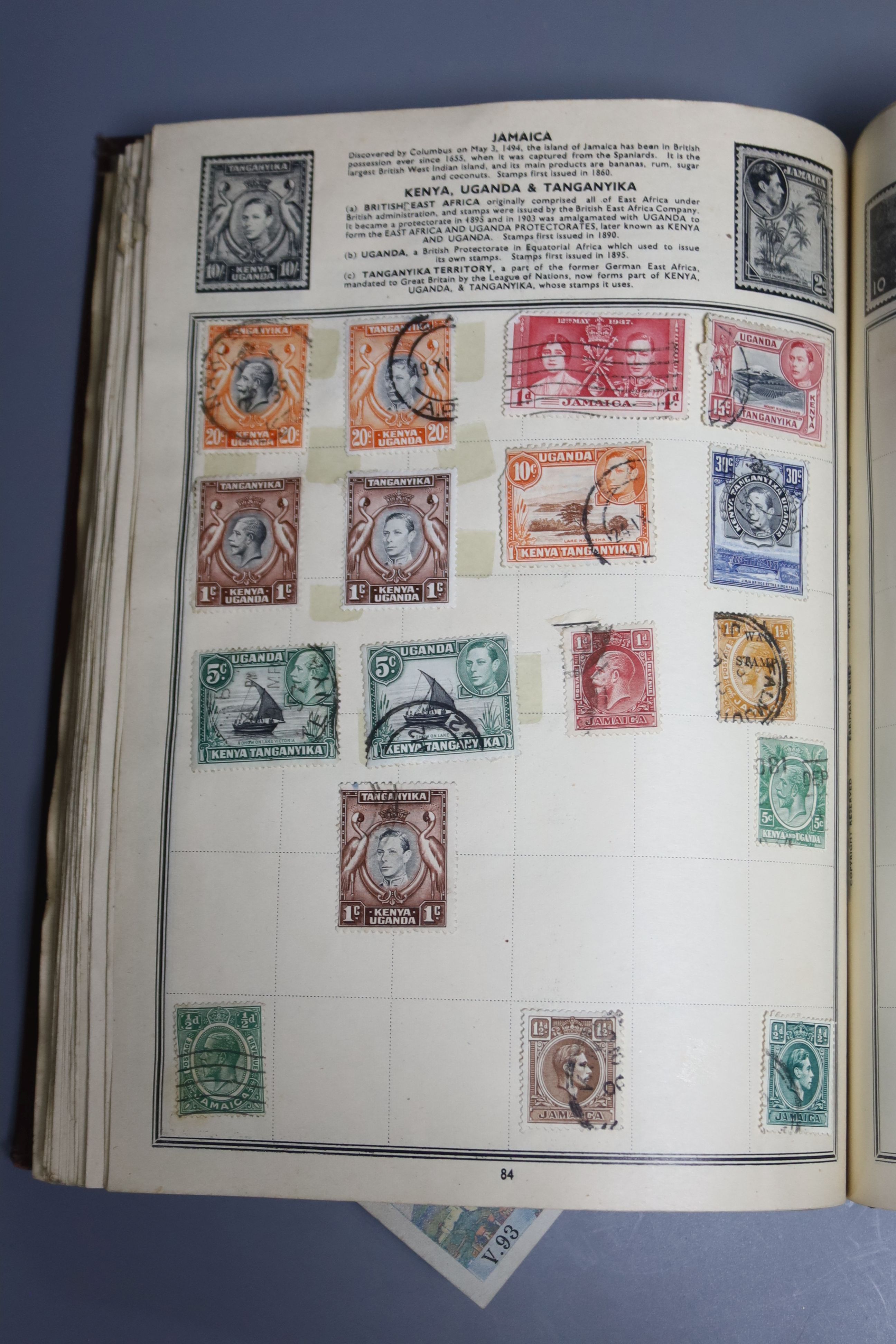 A Pacific stamp album with mixed world stamps, together with two pairs of brass candlesticks (5)